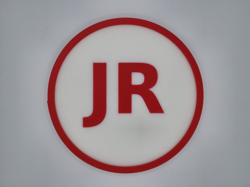 3D-printed drink coaster with a monogram inlaid flush in Matte Lava Red on Cotton White